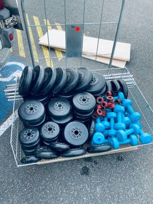 a cart full of wheels and blue dumbs on the street