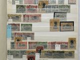 an open book sitting on top of a table covered in stamps