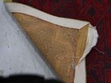 a close up of a rug with a piece of fabric on it