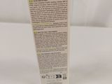 a close up of a tube of cream on a white surface