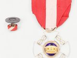 a medal and a medal pin on a white surface