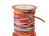 an orange spool with a spool of colorful ribbons on it