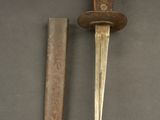 an old knife with a wooden handle next to a small knife