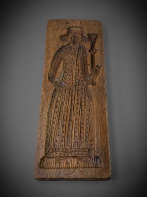 a carved plaque with a woman holding a flower in her hand