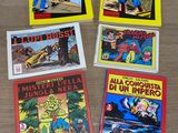 four comics are sitting on a table next to each other