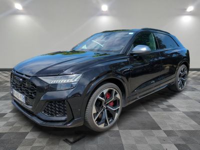 a black audi suv parked in a showroom with a checkered floor