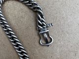 a silver chain that has a clasp on it