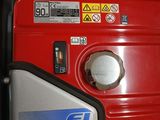 a red and black generator sitting on top of a counter