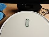 a white robot that is sitting on a table next to a monitor