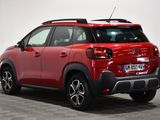 the rear end of a red citrole parked in a room
