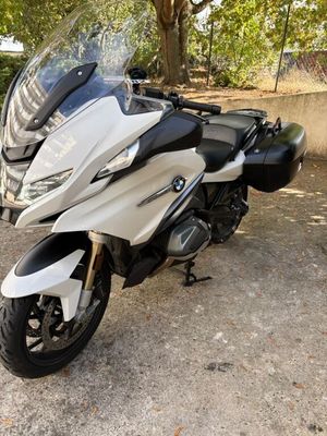 a white and black motorcycle parked in a parking lot
