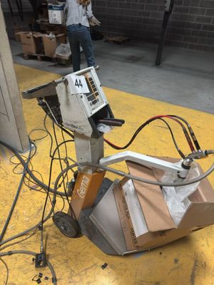 a machine that is sitting on the ground in a warehouse