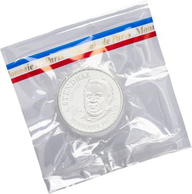 a close up of a coin in a plastic bag on a white background