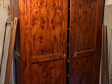 a large wooden armoire in the middle of a room