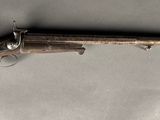 an old gun with a wooden handle on a white background