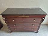 a wooden chest of drawers with a marble top