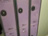 purple lockers are lined up against a wall in a room