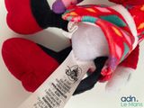 a small stuffed animal with a tag on it ' s neck