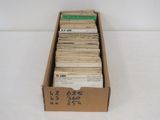 an open cardboard box filled with lots of papers on top of a white surface