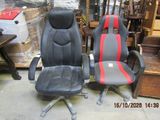 two black and red office chairs sitting next to each other in a warehouse