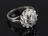 a close up of a diamond ring on a black surface
