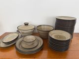 a lot of plates and bowls on a wooden table