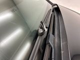 a close up of a car windshield with a cell phone on it