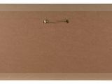 a brown bulletin board with a gold pin on it