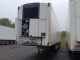 two semi trucks that are parked in a parking lot