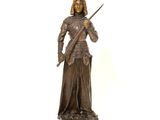 bronze statue of a woman holding a sword and a sword in her hand