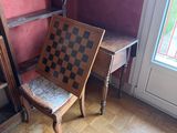 a chair that is sitting in front of a book shelf