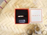 a box with a ring inside of it on a table