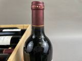 a bottle of red wine in a wooden box