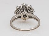 a close up of a diamond ring on a white surface