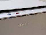 a white laptop sitting on top of a white box