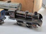 two toy trains sitting next to each other on a table
