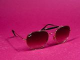 a pair of sunglasses on a pink background