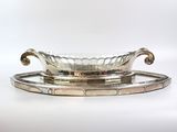 un plateau ancien en argent avec un bol en verre posé dessus