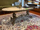a marble top coffee table on a rug in a living room