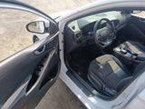 the interior of a car with the door open and the driver ' s seat down