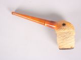 a pipe with a wooden handle on a white surface