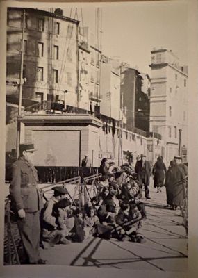 a black and white photo of a group of people on the street