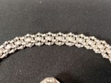 a close up of a bracelet on a black surface