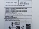 the back side of a white laptop with a sticker on it