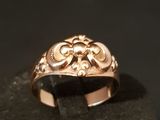 an image of a gold ring on a black surface