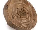 an old wooden object on a white surface with a white background
