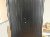 a large metal door in the corner of a room