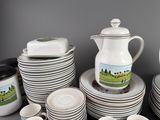 a lot of dishes and cups on the table