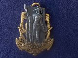 an image of a pin with a statue of a man holding a sword