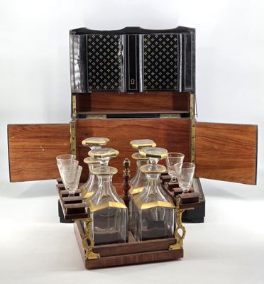 bottles and glasses in a wooden case on a white background
